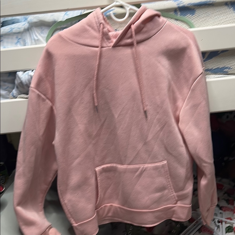 Pink hoodie with kind words on the back